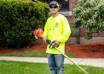 NAL team weed whacking commercial property.