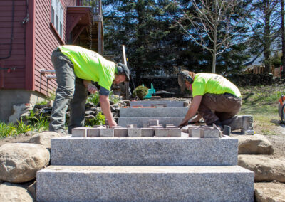 Our hardscaping team installing a new walkway & steps.